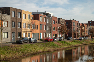 Fototapeta na wymiar New modern residential buildings along the canal in the Vathorst district in Amersfoort.