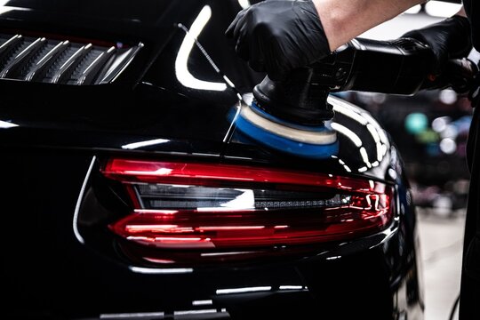 Precision auto detailing, high-gloss finish on luxury car