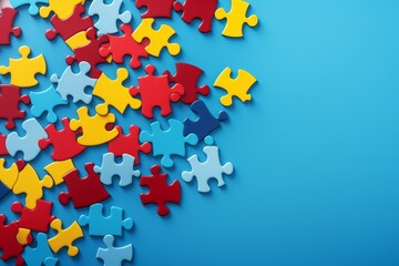 World Autism Awareness Day or month concept. Creative design for April 2. Blue, red, yellow jigsaw puzzles, symbol of awareness for autism spectrum disorder on blue background. Top view, copy space