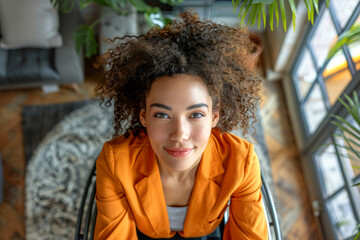 An afro young businesswoman in wheelchair at office, disability person. - obrazy, fototapety, plakaty