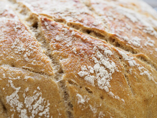 Close-up of freshly baked bread with flour dusting.