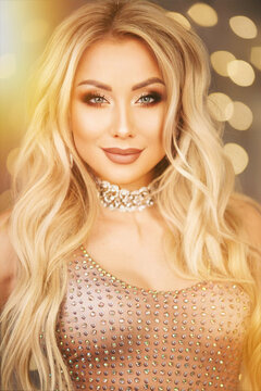 Portrait of a charming blonde woman posing in studio over pink background.