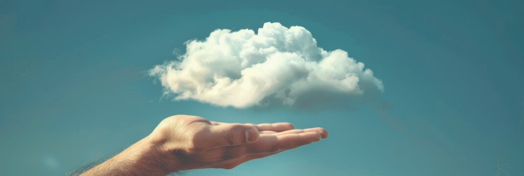 Surreal Cloud on Hand - A creative and surreal image of a fluffy white cloud resting on a human hand against a clear blue sky. Symbolizes care, dreams, and the power of imagination.