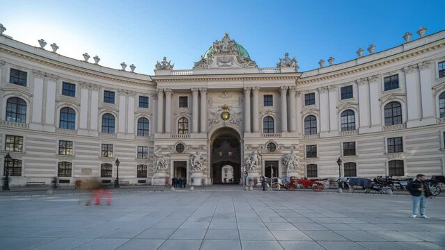 Hofburg palace timelapse hyperlapse in Vienna, Austria. People walking on Michaelerplatz. The Hofburg is the imperial palace of the Habsburg rulers in Vienna. Sisi Museum Hofburg Wien