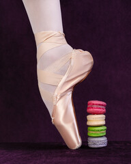 ballerina's feet in pointe shoes and bright sweets. Dance concept