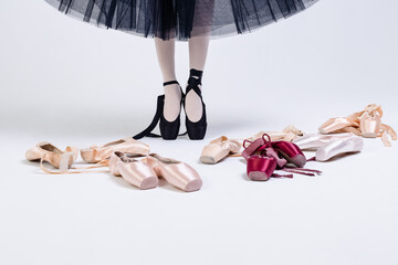 Ballerina's legs on pointe shoes close-up. The concept of achieving success in classical and modern...