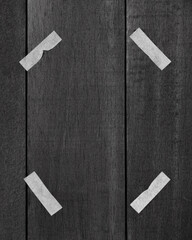 Artistic representation of an anonymous person with taped eyes on wooden texture