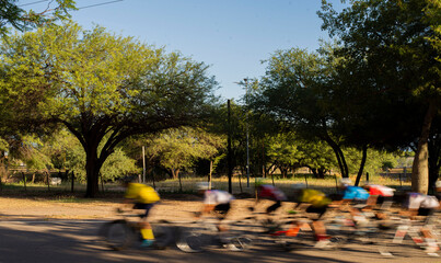 group of cyclists competing in speed race