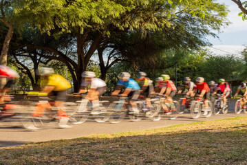 group of cyclists competing in speed race
