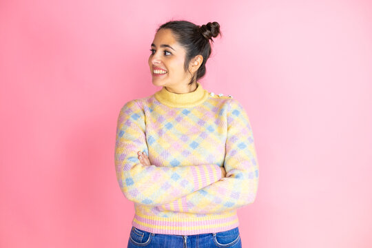 Young beautiful woman wearing casual sweater over isolated pink background looking to side, relax profile pose with natural face and confident smile.