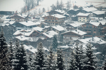 heavy snowfall in a ski resort in Austria, big snowflakes, houses covered with snow
