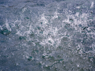 The raindrops of heavy rain on asphalt. Splashes from the rain