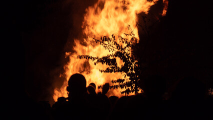Bonfire with flames illuminating the surroundings. The image captures the practical elements of a bonfire scene, suitable for various purposes
