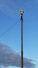 Fototapeta premium Street lamp post on blue sky background vertical format photography