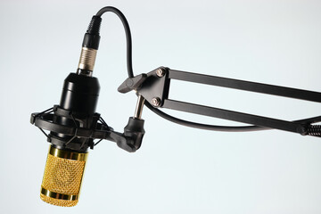 Studio microphone for podcast and voice recording on a gray background with space for inscription