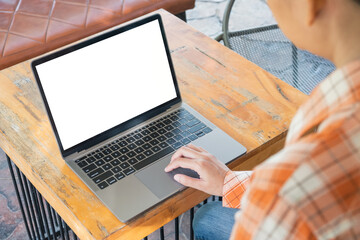 Woman using blank laptop in the cafe.