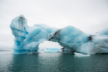 Closeup of an iceberg arch in Jokulsarlon glacier lagoon. travel destination and seascape concept