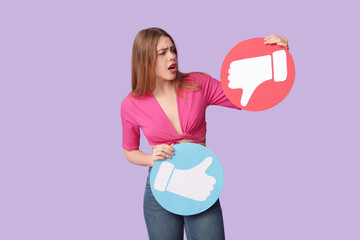 Beautiful young displeased woman with like and dislike icons on purple background