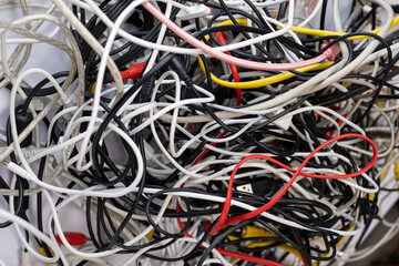 A pile of various used tech peripheral cables, connectors, and plugs, including universal standards...