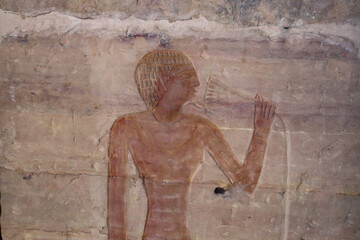 ancient egyptian wall relief at tombs of the Nobles in Aswan, Egypt