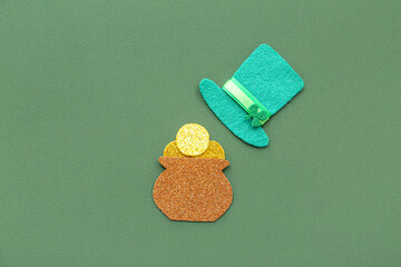 Paper pot with golden coins and leprechaun hat on green background. St. Patrick's Day celebration