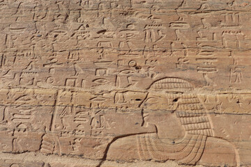 ancient egyptian carvings and hieroglyphics at tombs of nobles in Aswan, Egypt 