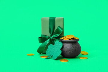 Pot with golden coins, gift box and clover on green background. St. Patrick's Day celebration