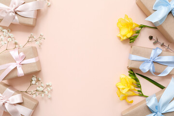 Composition with cute wrapped gift boxes decorated with flowers on beige background