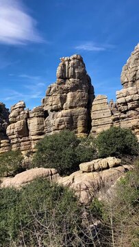 Hiking the Torcal de Antequerra National Park, limestone rock formations and known for unusual karst landforms in Andalusia, Malaga, Spain.