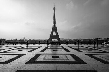 Eiffel Tower, French: Tour Eiffel, silhouette at dawn. View from Trocadero Square with geometrical marble pavement. Paris, France. Black and white photography.