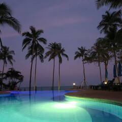 Pool by the sea, beautifully lit in the evening without people
