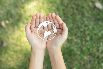 Top view hand holding Earth planet icon symbolize eco-friendly commitment to environmental...