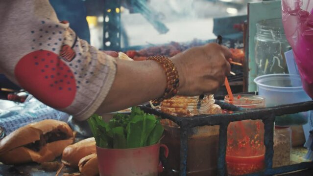 Experience Vietnam's vibrant street food scene with the iconic Banh Mi. Succulent marinated skewers grilled over street barbecue stands offer a spicy delight, making it a beloved favorite among locals