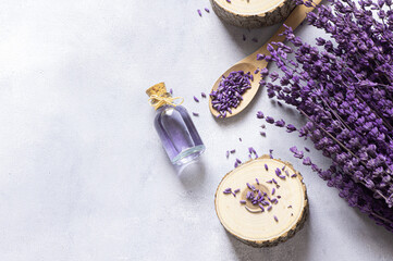 Glass bottle of Lavender essential oil with dried lavender flowers and seeds, close up aromatherapy spa massage concept. Lavendula oleum