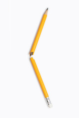 Broken pencil on white background close-up on vertical background. Graphite yellow pencil, broken...