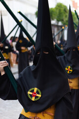 Penitent or Nazarene carrying a candle during a Holy Week procession.