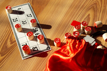 Classic Bingo Game with Wooden Numbers in Sunlight.