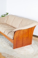 Vintage Sculpted Wood Frame Sofa. Stylish Leather Couch. Interior photograph.
