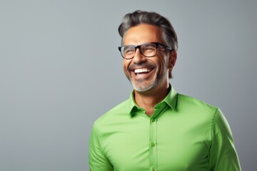 Fototapeta premium Happy smiling middle-aged businessman Confident professional businessman wearing colored shirt on gray background Advertising glasses lenses