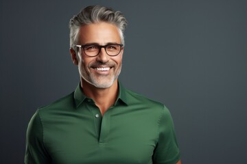 Obraz premium Happy smiling middle-aged businessman Confident professional businessman wearing colored shirt on gray background Advertising glasses lenses