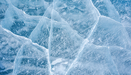 Beautiful winter natural blue ice texture of surface of frozen Baikal Lake in cold day. Nature abstract pattern of white cracks. Winter seasonal background, mock up, flat lay, blank, closeup, top view