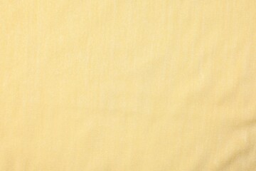 Texture of soft yellow fabric as background, top view