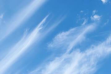 delicate patterns of white clouds in the blue sky