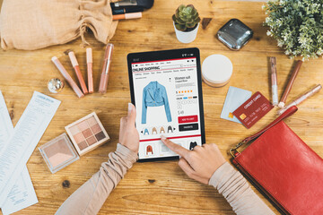 Woman shopping online on internet marketplace browsing for sale items for modern lifestyle and use credit card for online payment from wallet protected by crucial cyber security software - obrazy, fototapety, plakaty