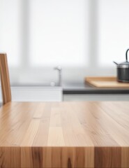 Wooden table with a background of a blurry kitchen bench. A wooden table that is empty and a fuzzy kitchen background