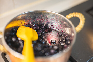 Making blueberry jam in copper pot, home baking, colorful, blue, fruit, jam making