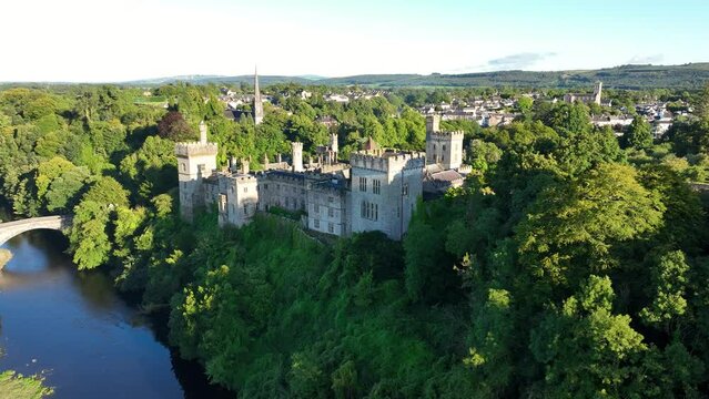 Amazing Castle against the backdrop of green trees. Aerial view in 4k