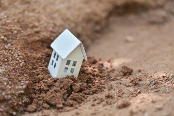 The white house collapsed or landslide from soil erosion. Soil erosion is the natural process in which the topsoil of a field is carried away by physical sources such as rainfall , flooding, wind, 