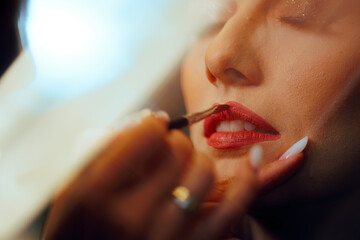 Detail of Lipstick Applied on a Client by Professional Makeup artist. Perfect red Lip achieved by a...