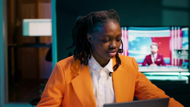 African american student working on her bachelor paper essay at home, writing ideas from online research. Girl exploring digital libraries and academic databases for additional resources. Camera A.